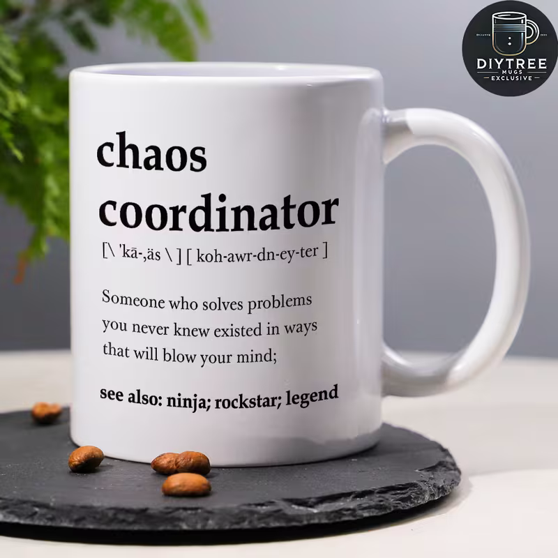 White ceramic mug printed with a dictionary-style definition of chaos coordinator